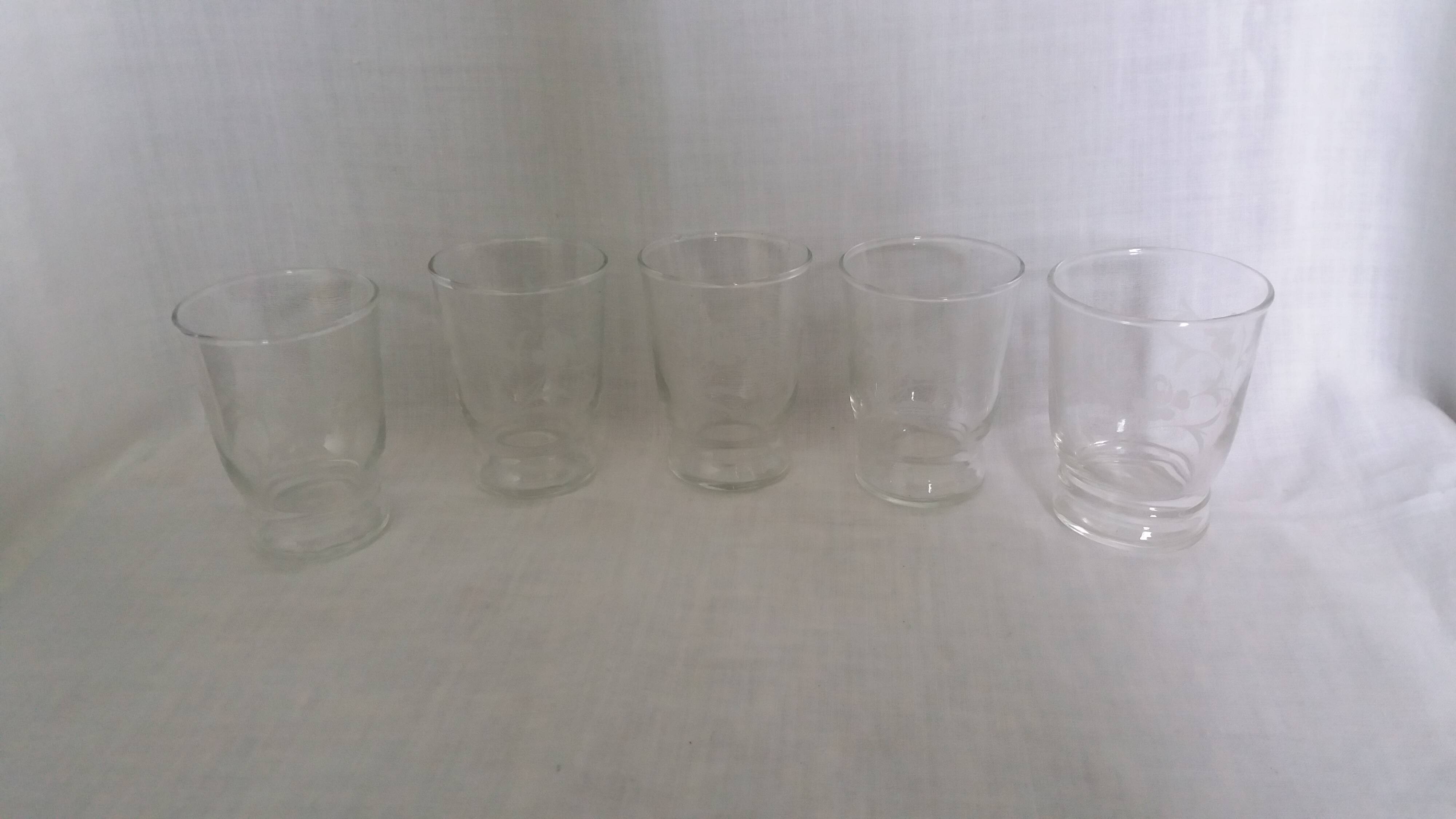 Old digestif or liqueur glasses, handcrafted glass with a floral pattern.