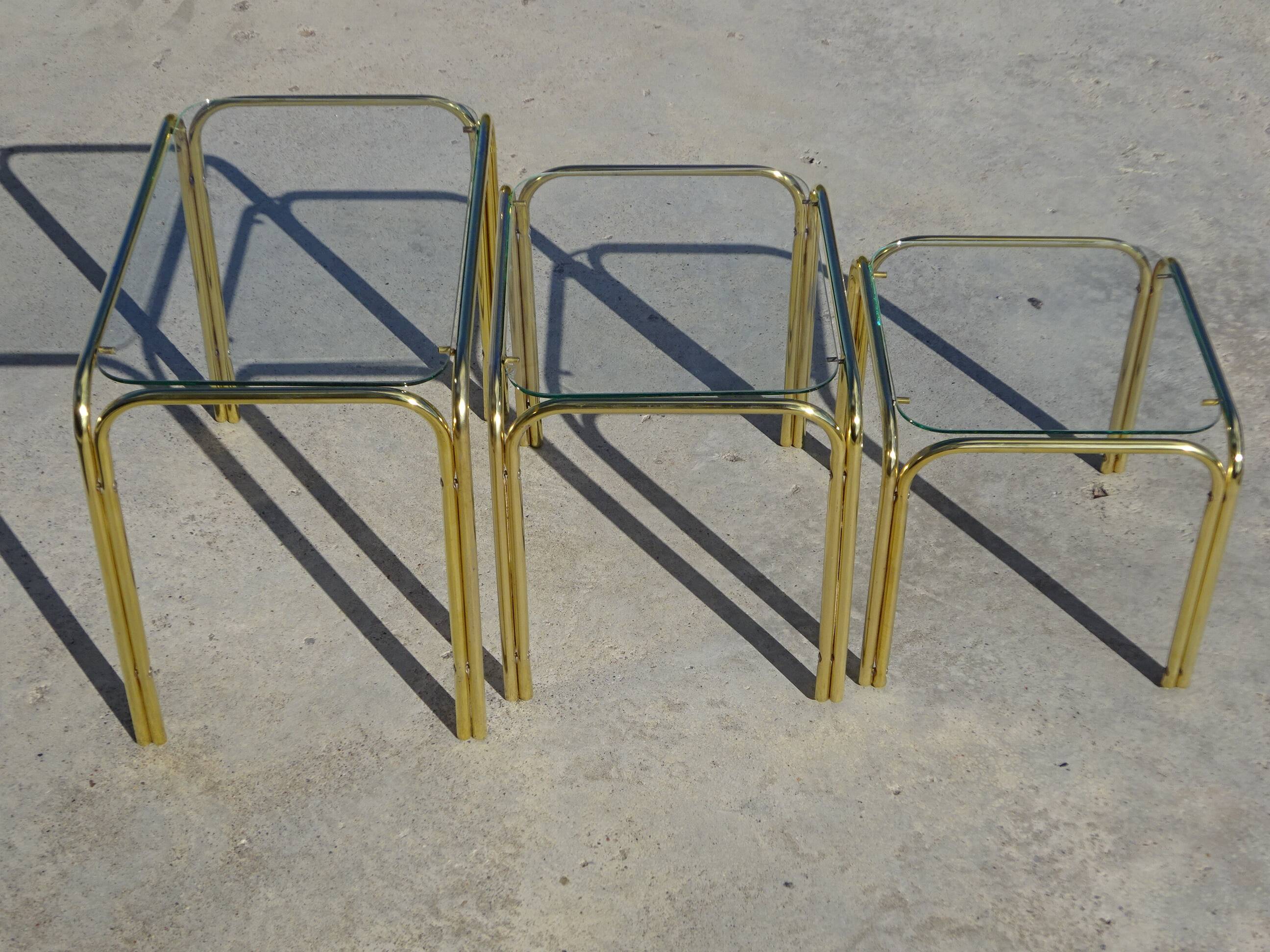 Nesting tables in gold-tone metal and glass