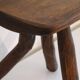 Patinated tripod stool in solid wood from the 1960s.