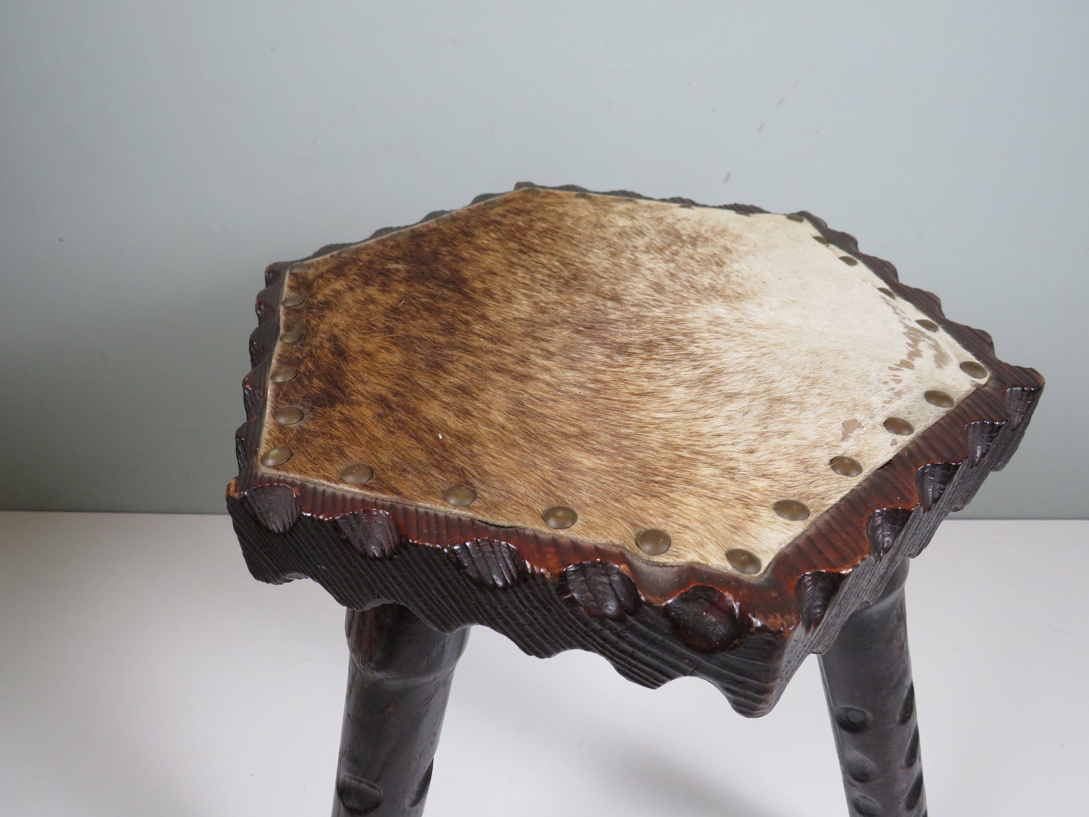 Vintage Spanish stool in carved wood with a leather seat.