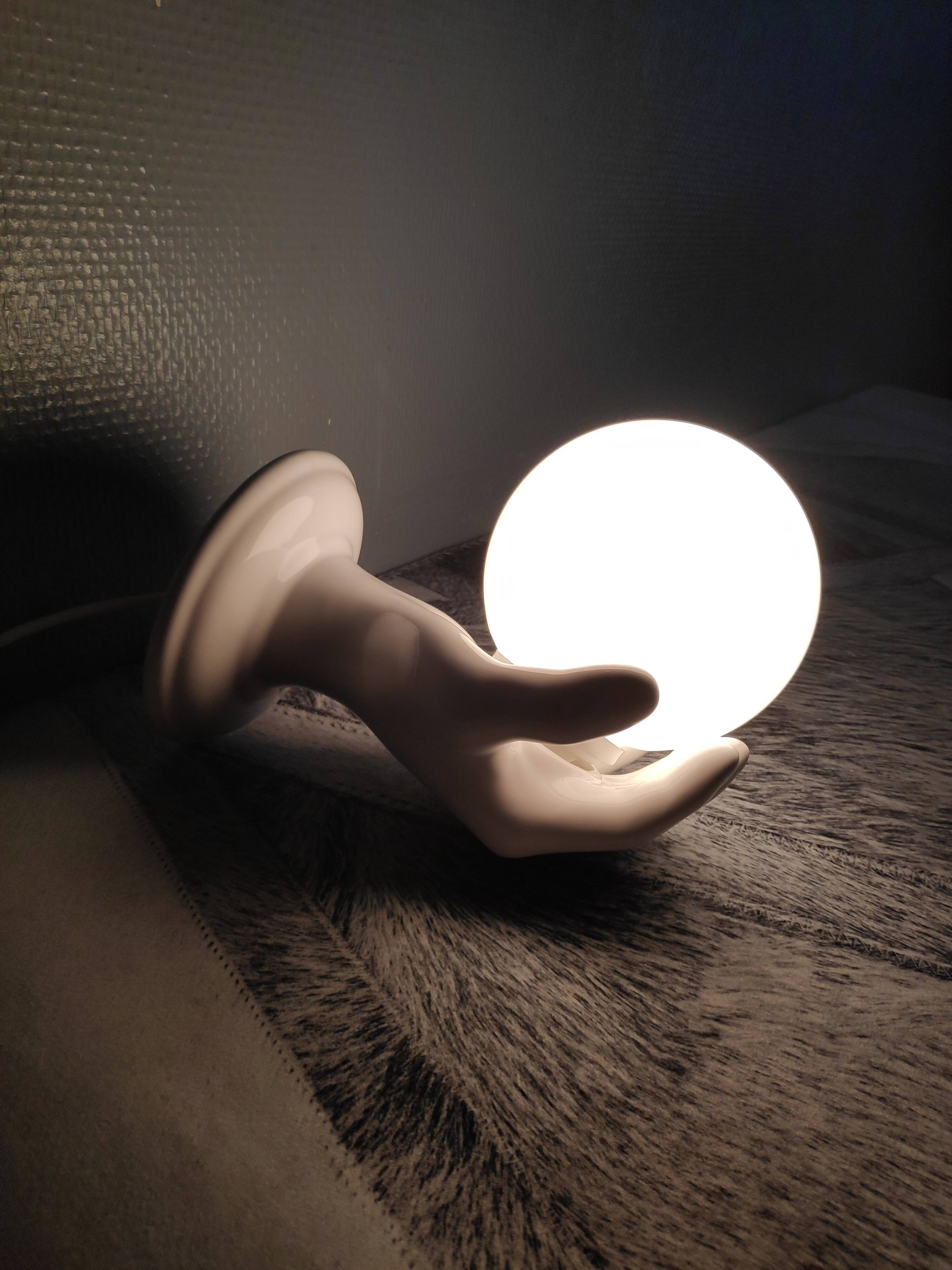 White ceramic hand sconce with white opaline globe