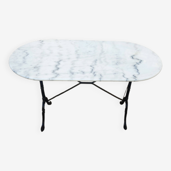 White and black oval marble table, wrought iron base