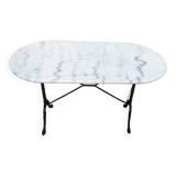 White and black oval marble table, wrought iron base