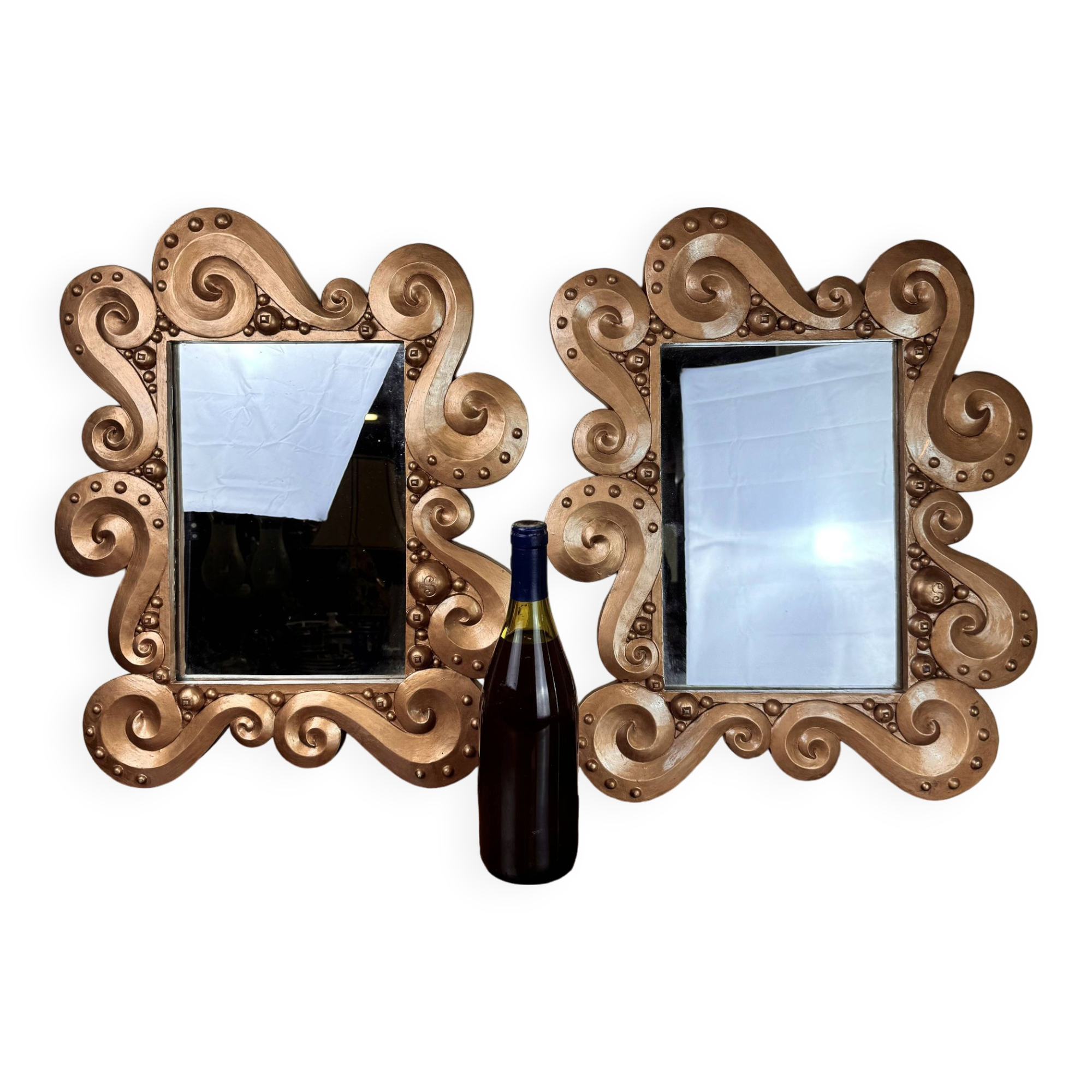 According to the model “the waves” by Jean Boggio: pair of designer gold mirrors circa 1980