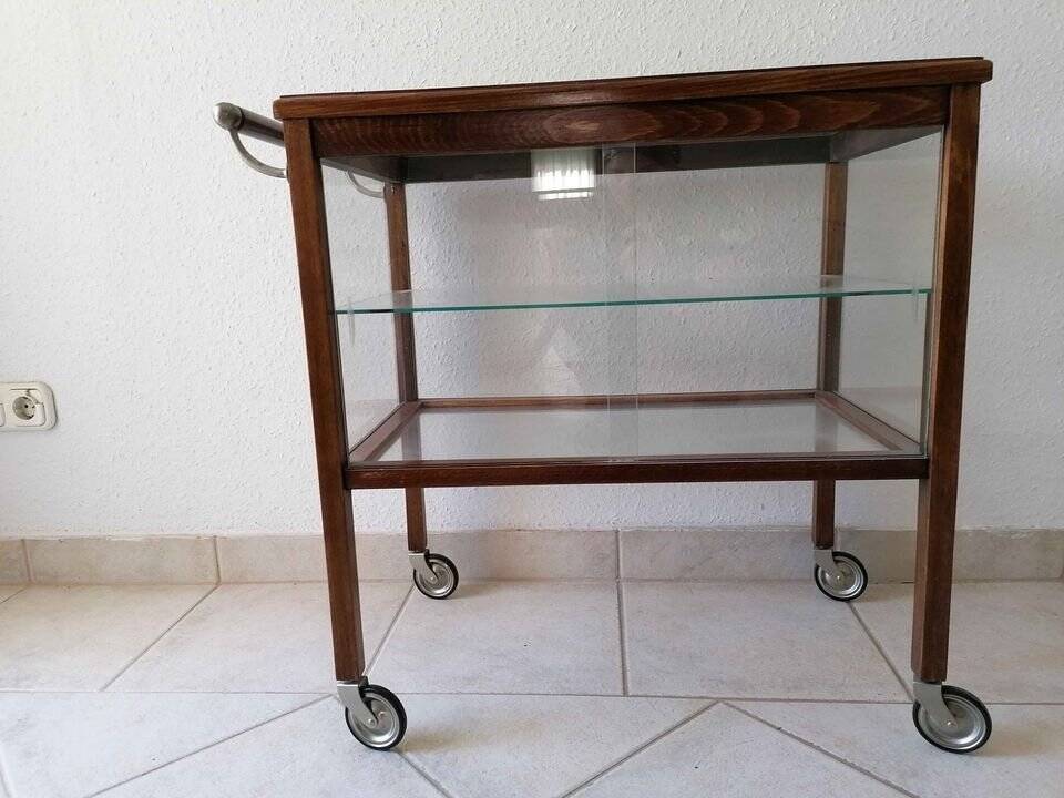 Art Deco brown wooden and glass bar cart, mobile display cabinet from the 1950s.