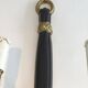 Pair of black lacquered bronze wall sconces decorated with lion heads