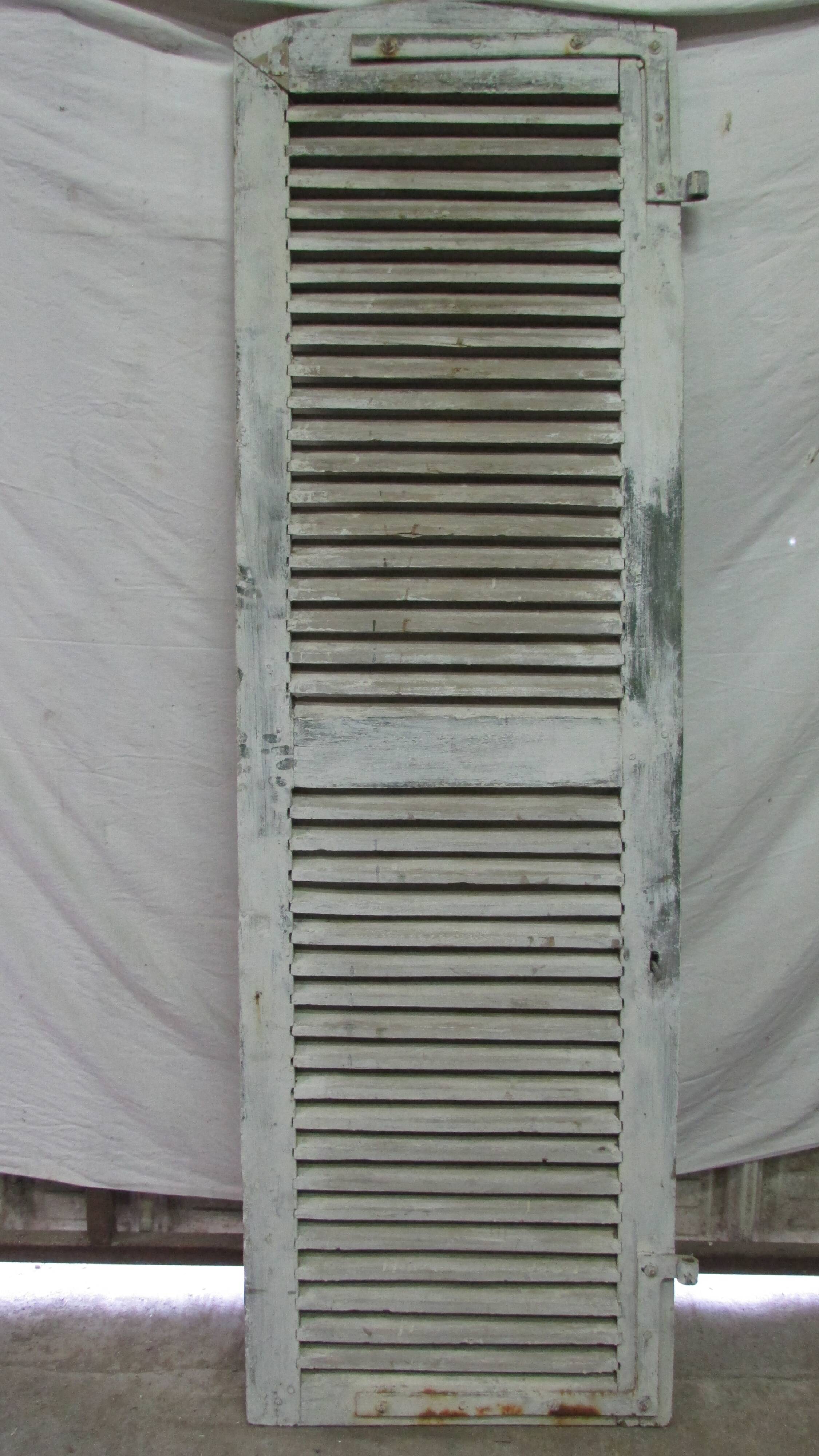 Old wooden shutter with perforations.