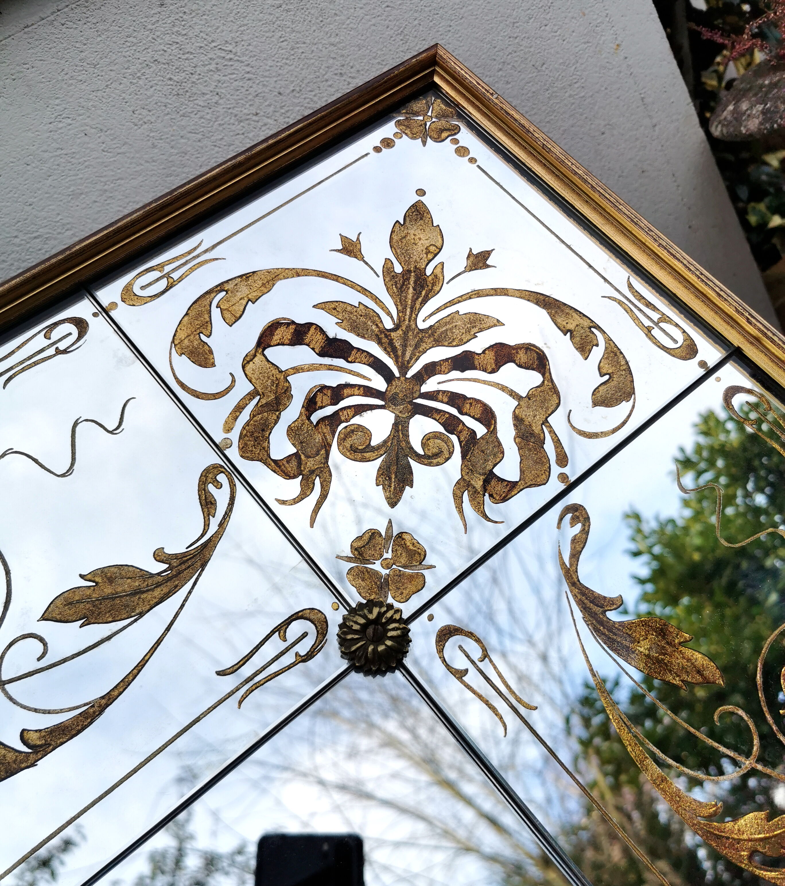 Glass mirror with a decoration engraved with golden foliage 1960