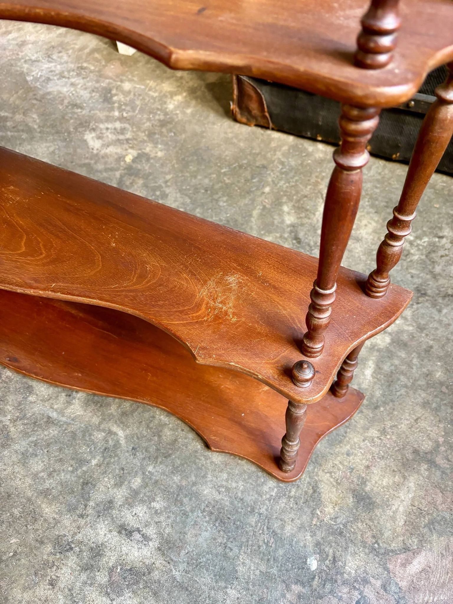 Curved and turned wooden wall shelf