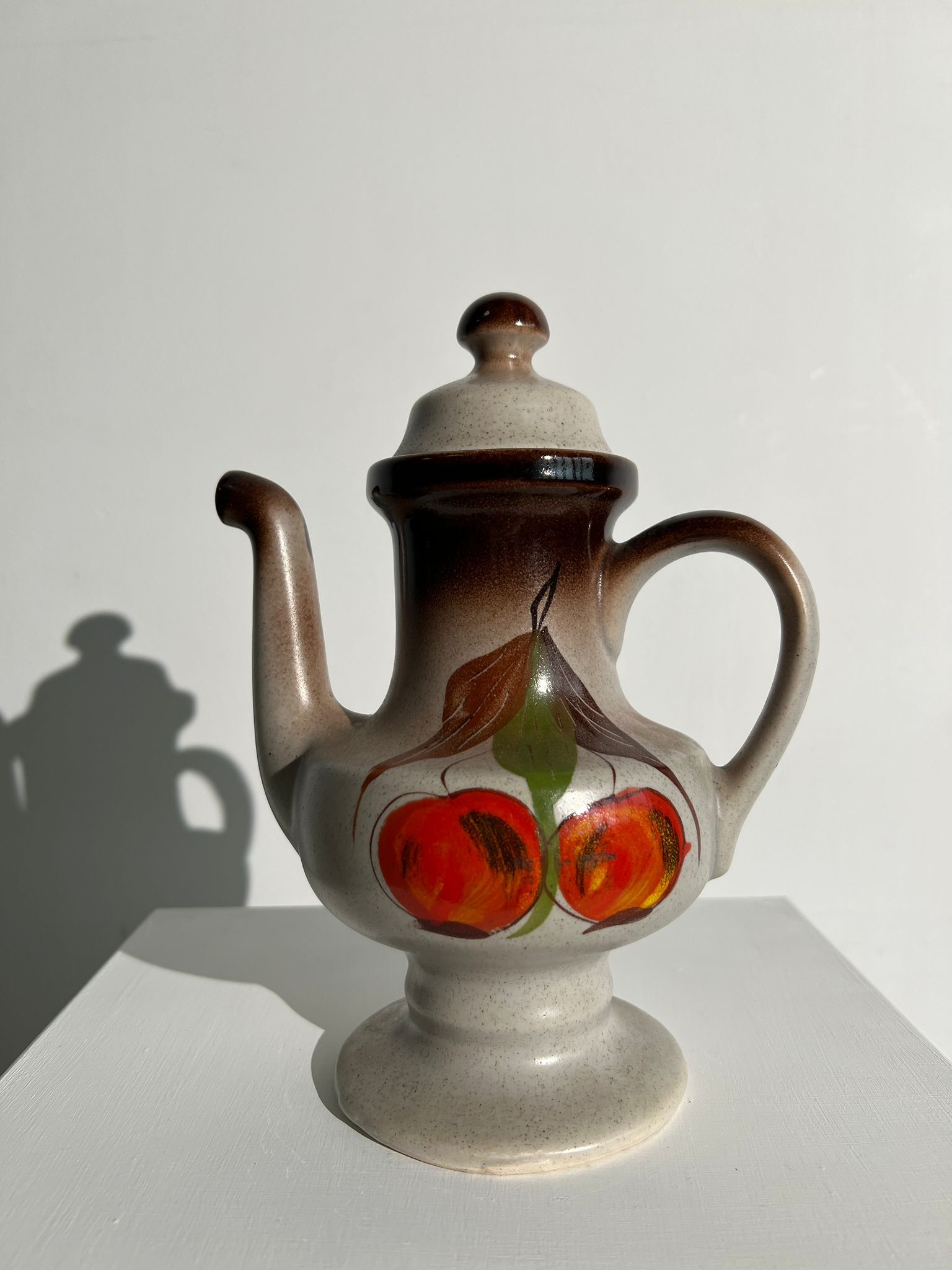 Vintage stoneware teapot with flower and fruit patterns