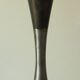 Set of three diabolo-shaped candle holders made of cast steel.