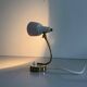 Simple table lamp with a pink metal head and brass body, 1960s, Germany.