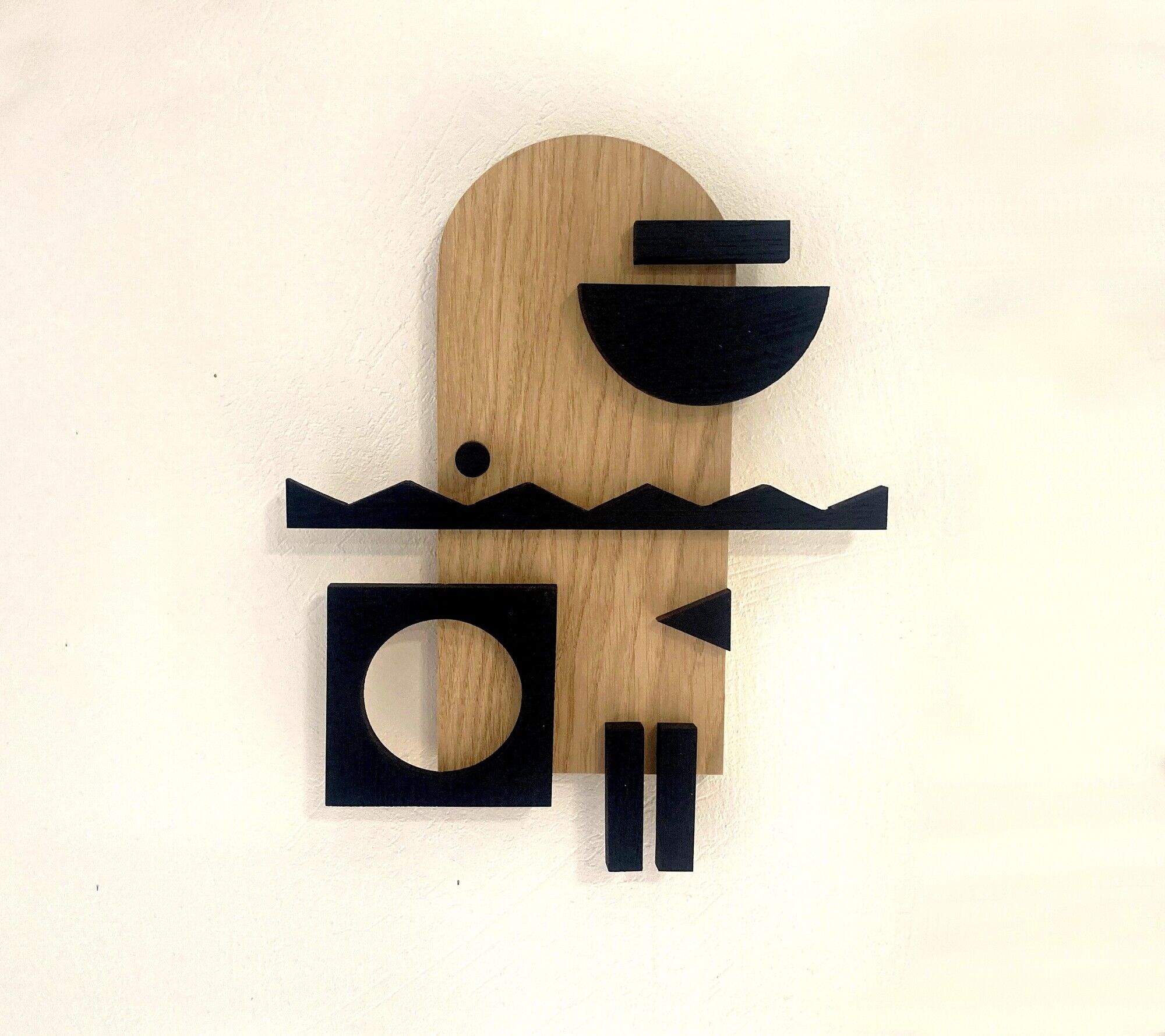 Geometric wooden painting - relief collage of natural and black wood