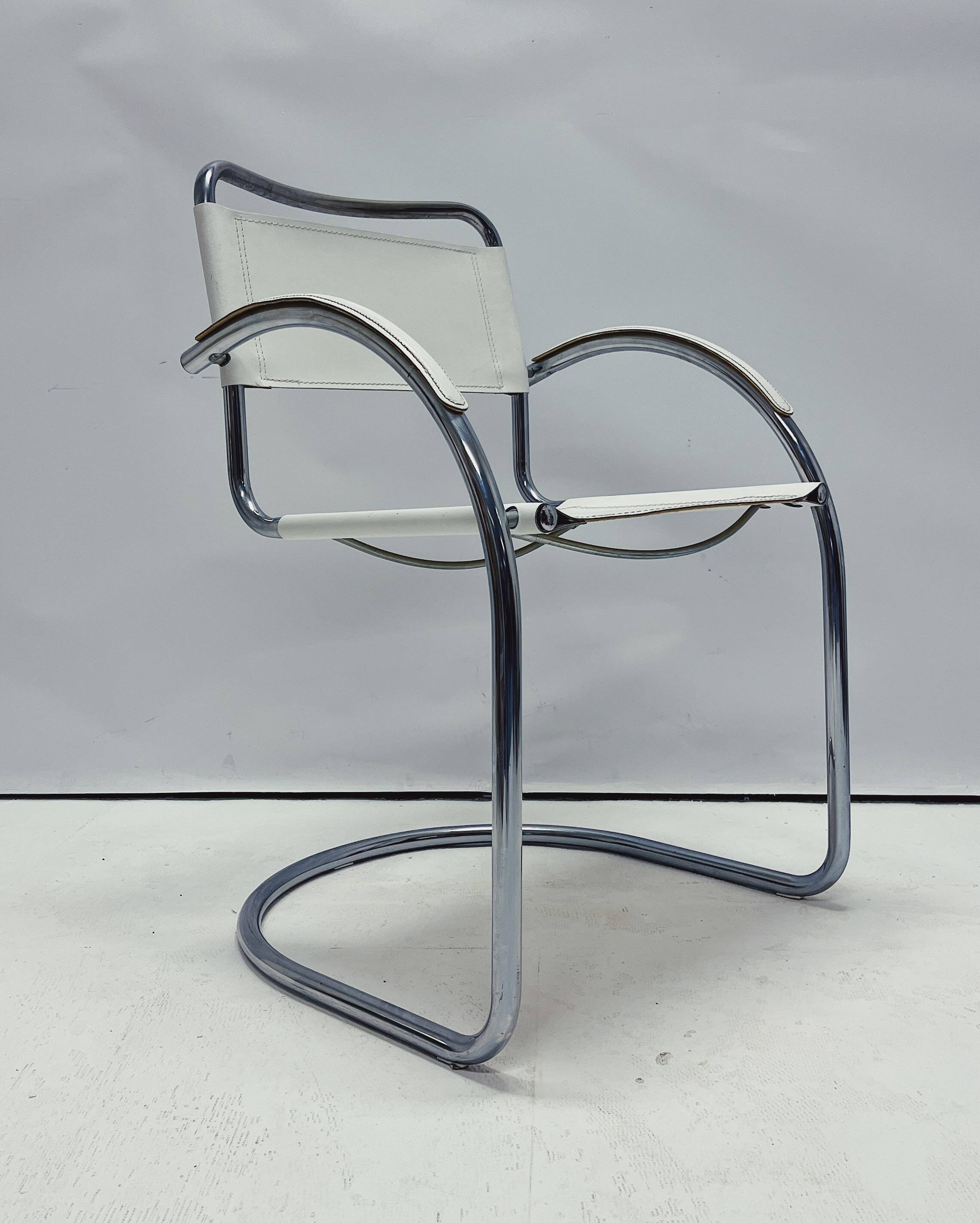 Vintage tubular frame chairs with white skai