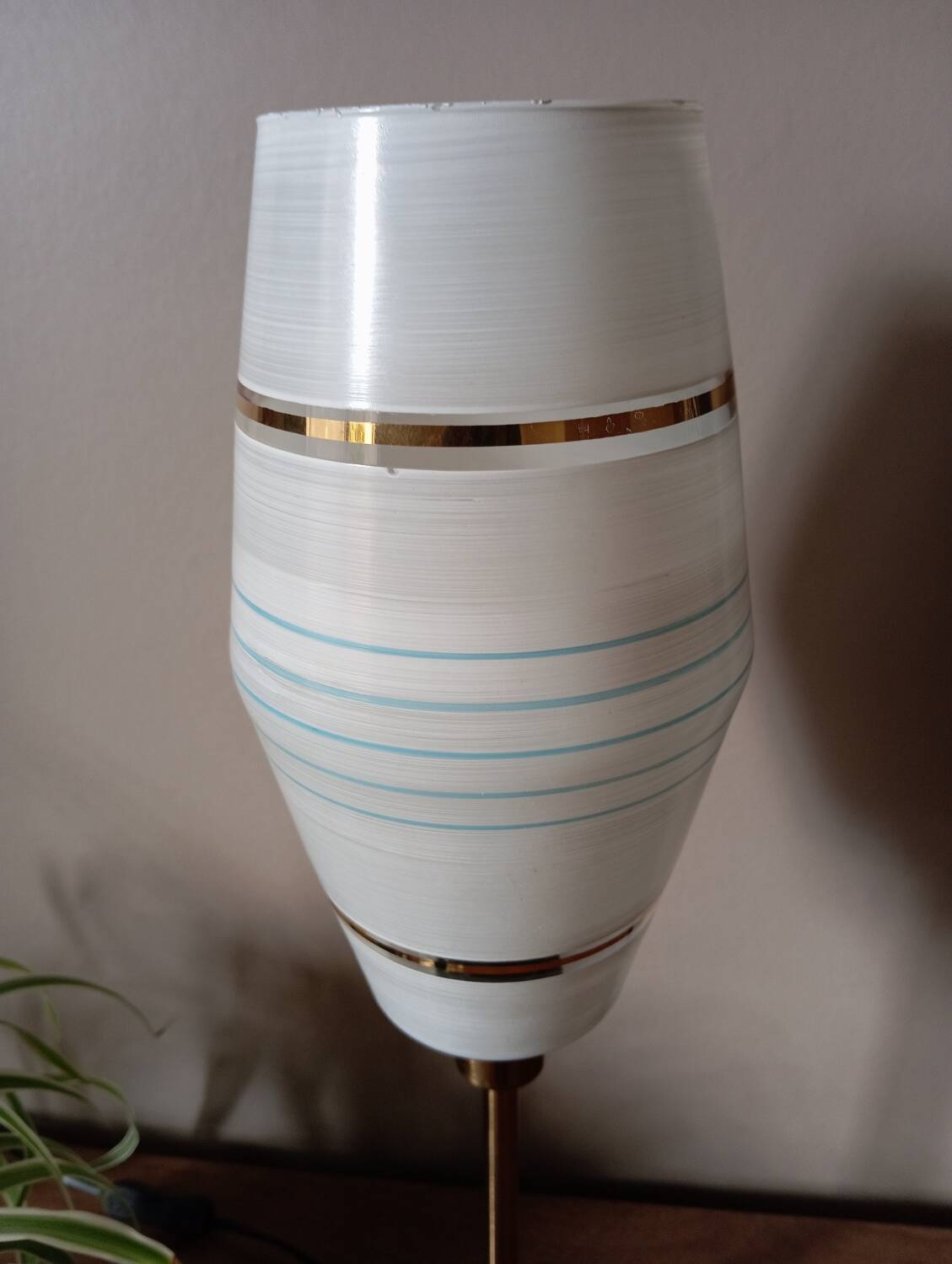 Mid-century gold metal table lamp with white striped shade