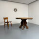 Round table in solid wood, thick top, vintage brutalist style from the 1960s.
