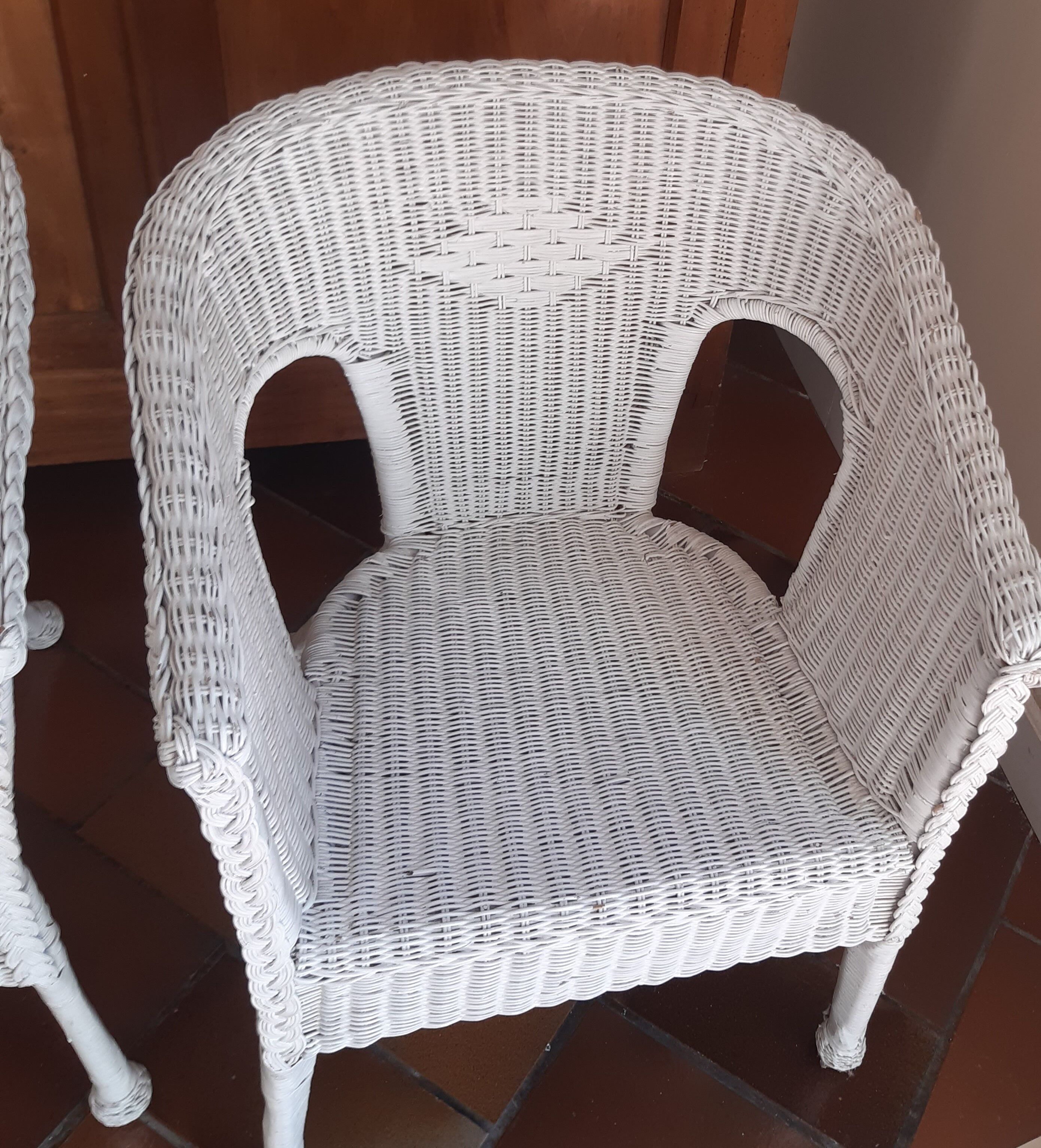 2 white wicker armchairs
