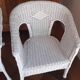 2 white wicker armchairs