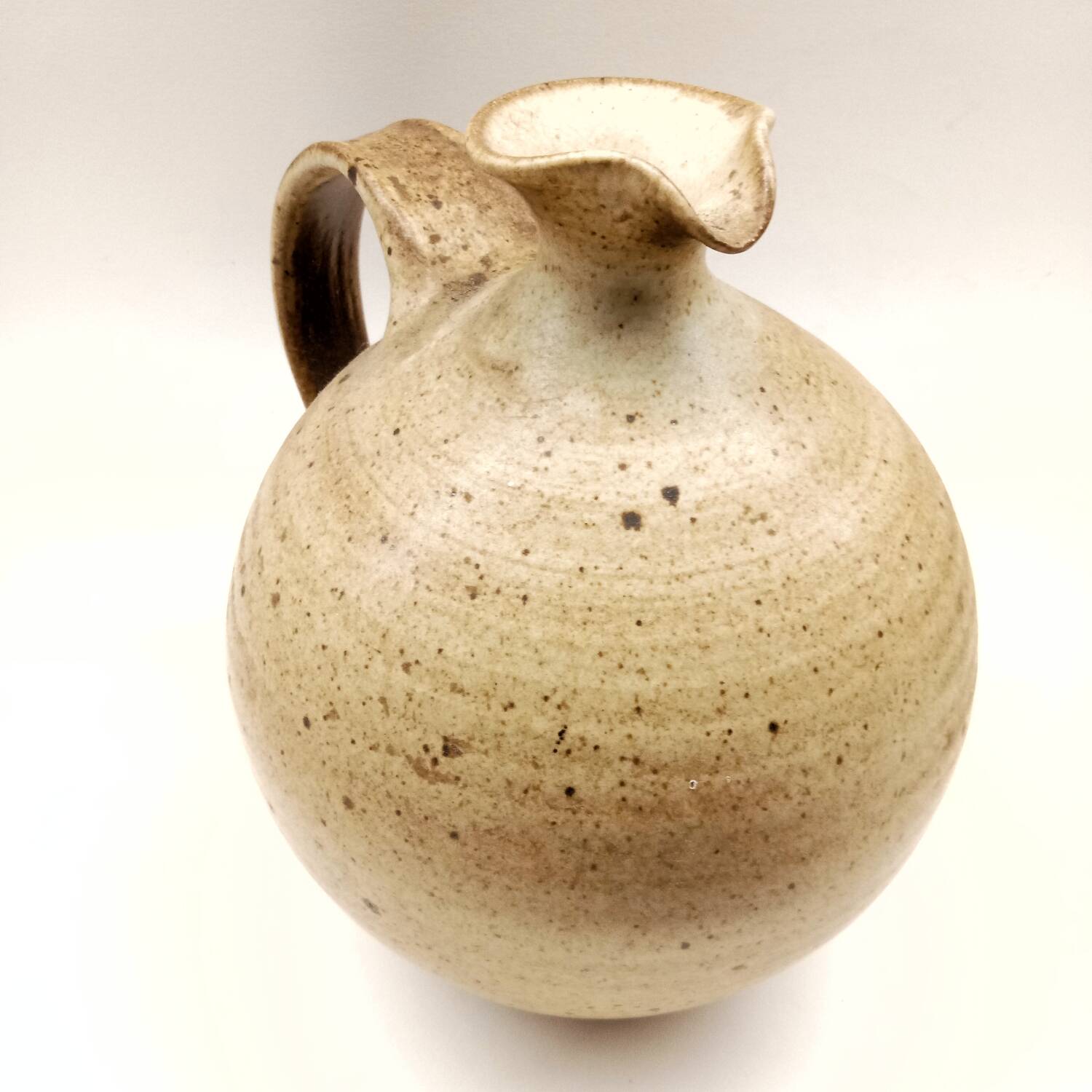 Vintage speckled brown stoneware jug in a round shape.