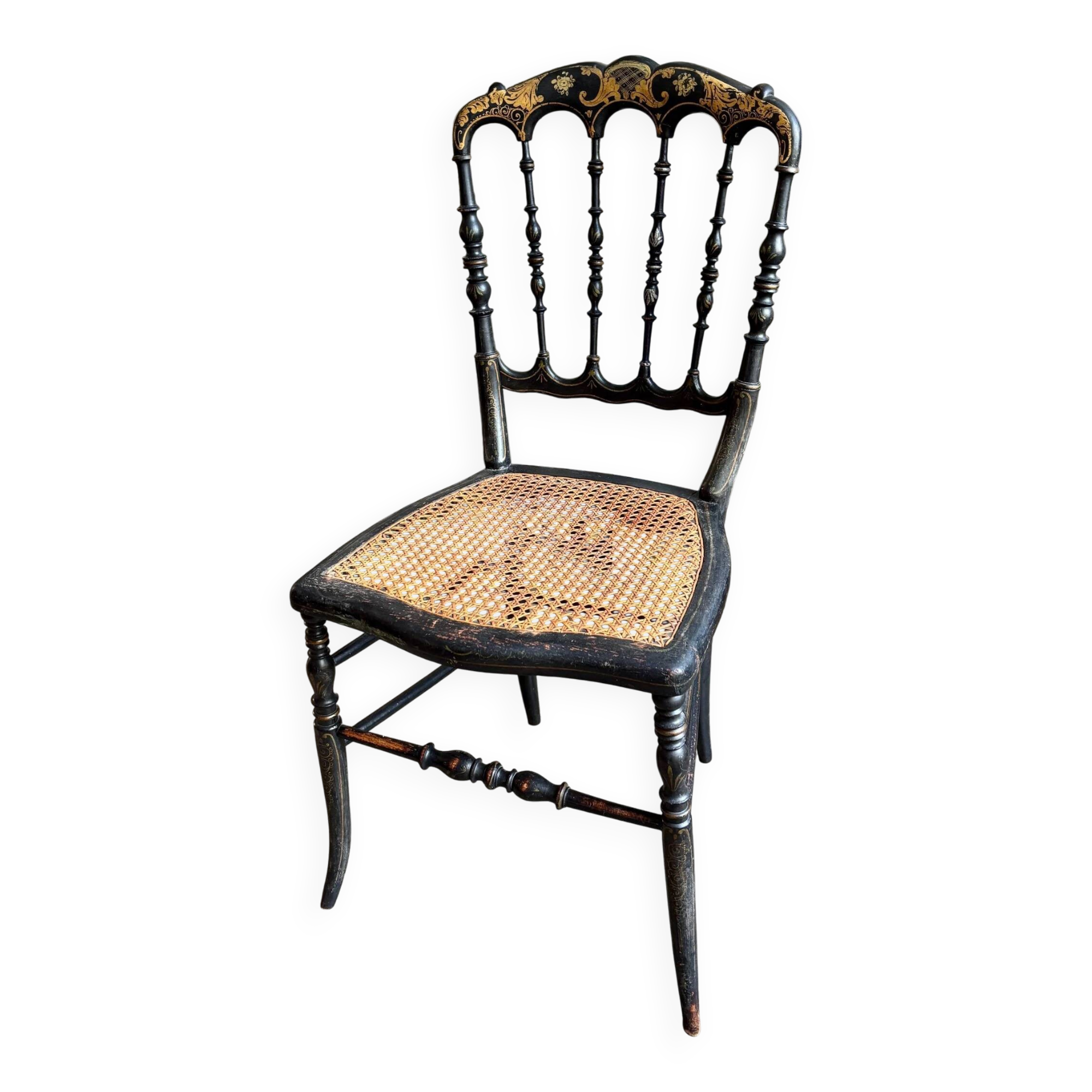 Napoleon III chair in black and gold wood with caning.