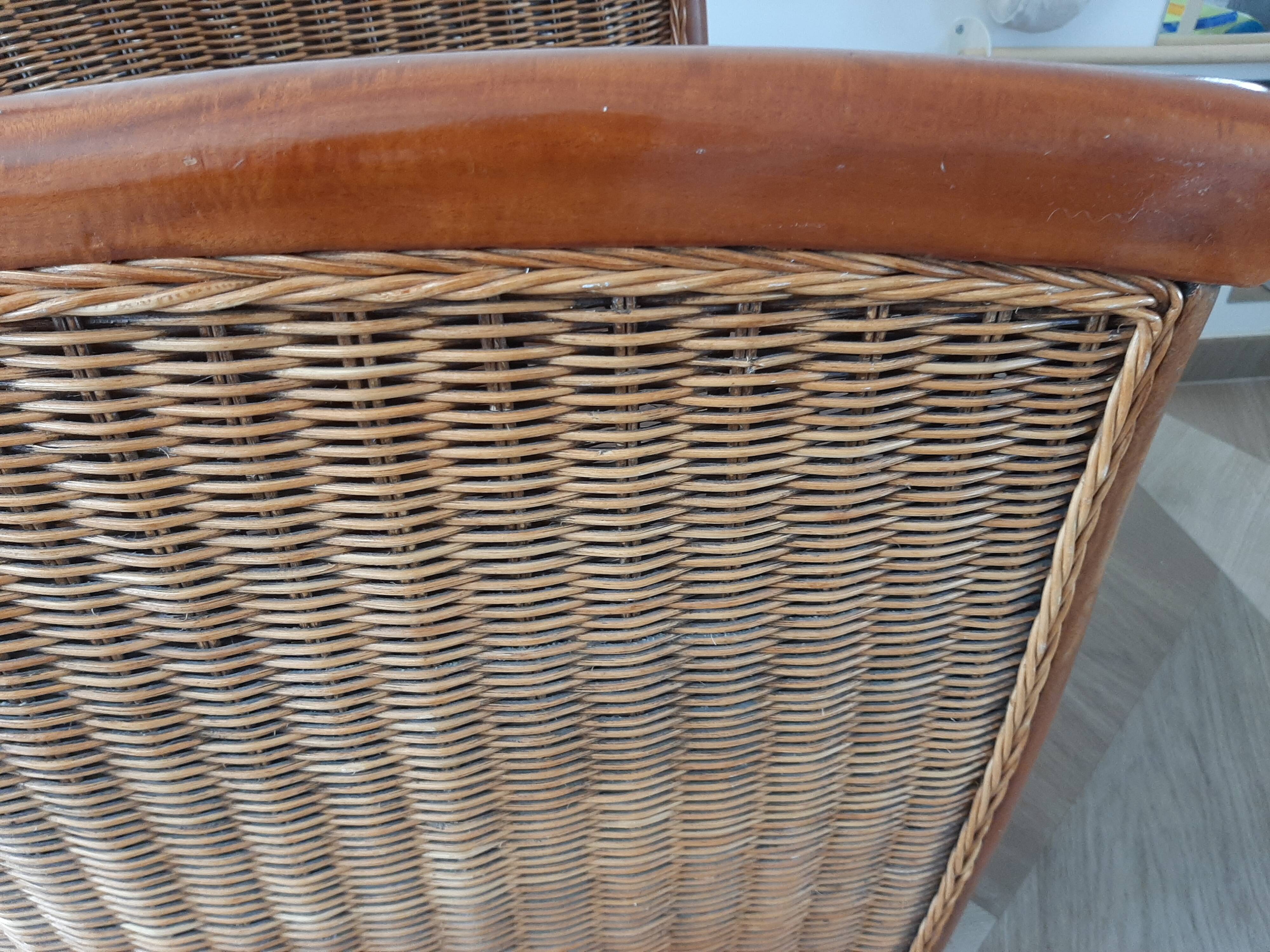 Armchair in woven rattan and exotic wood