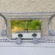 Vintage train style wall-mounted hat rack with angled mirror.