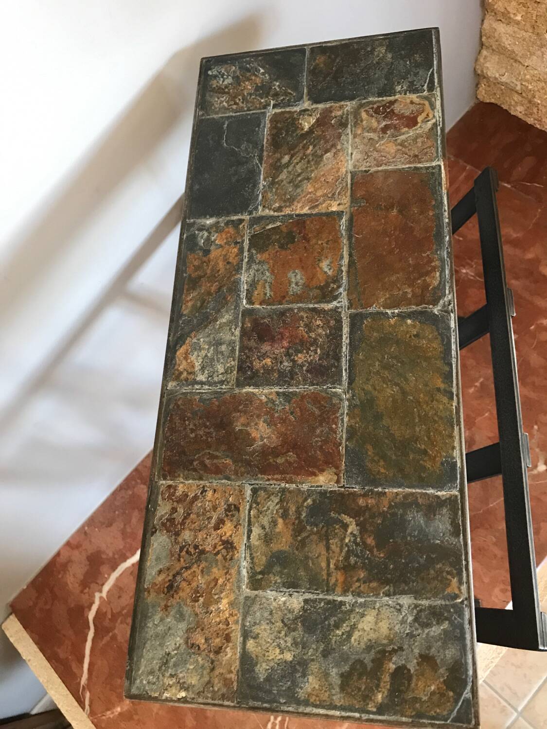 Iron and stone brutalist magazine rack