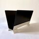 Black and cream metal magazine rack, 1950s.