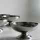 5 silver metal cups.