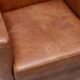 Pair of Art Deco armchairs in brown leather and teak, Netherlands, 1970s.