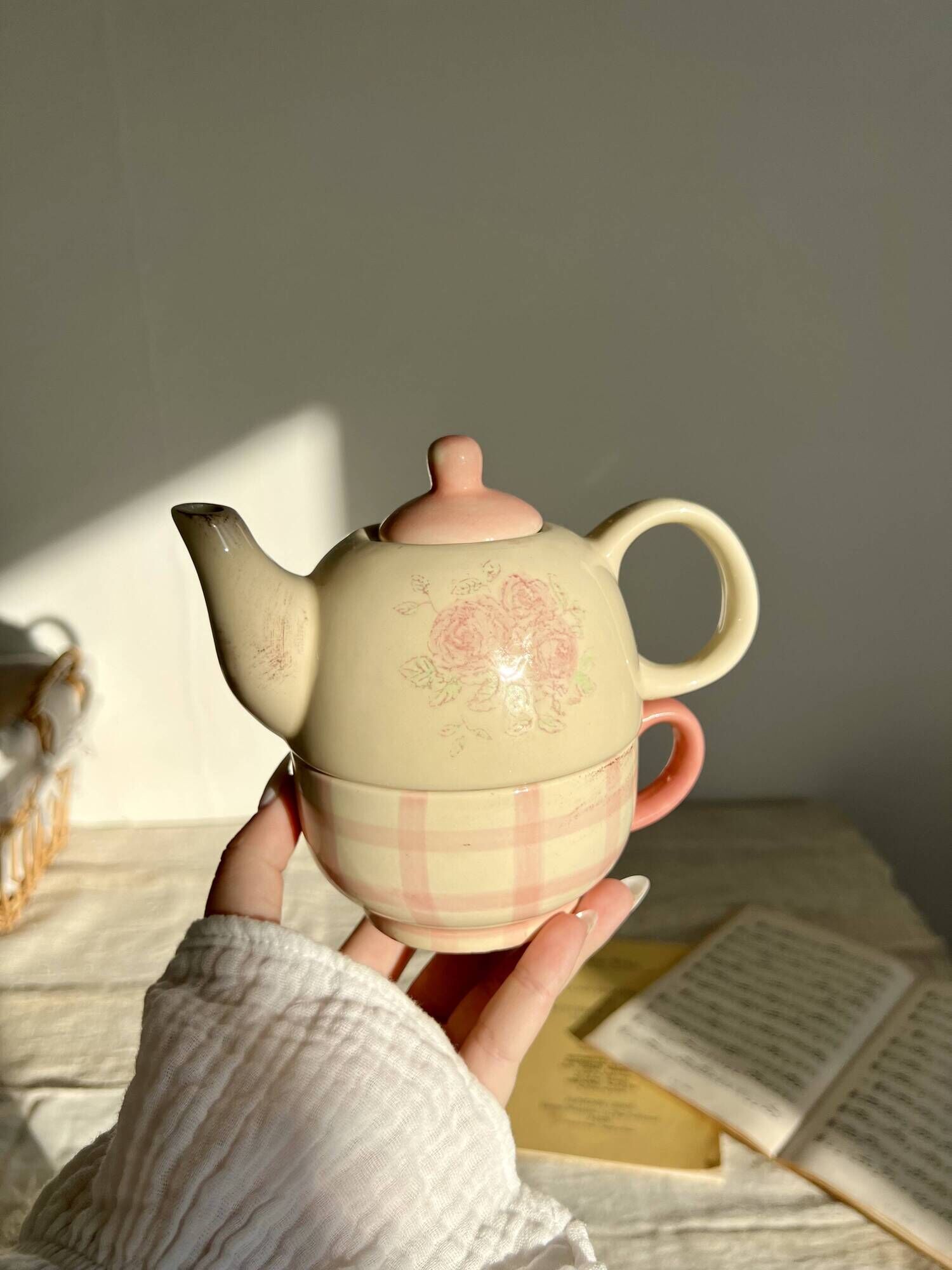 Vintage porcelain teapot and cup set with pink and beige floral and gingham pattern
