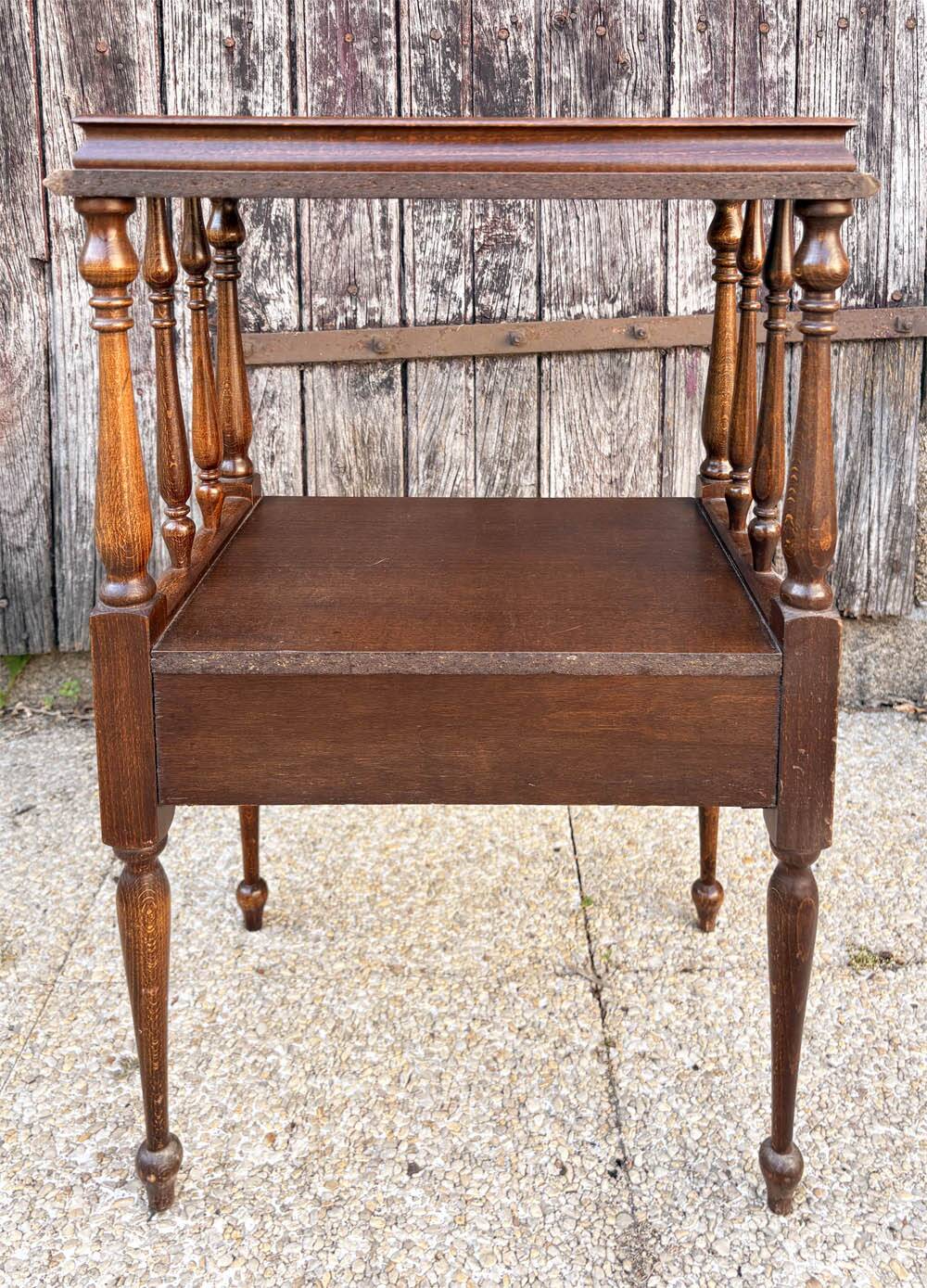 Solid wood bedside table with turned columns, early 20th century.