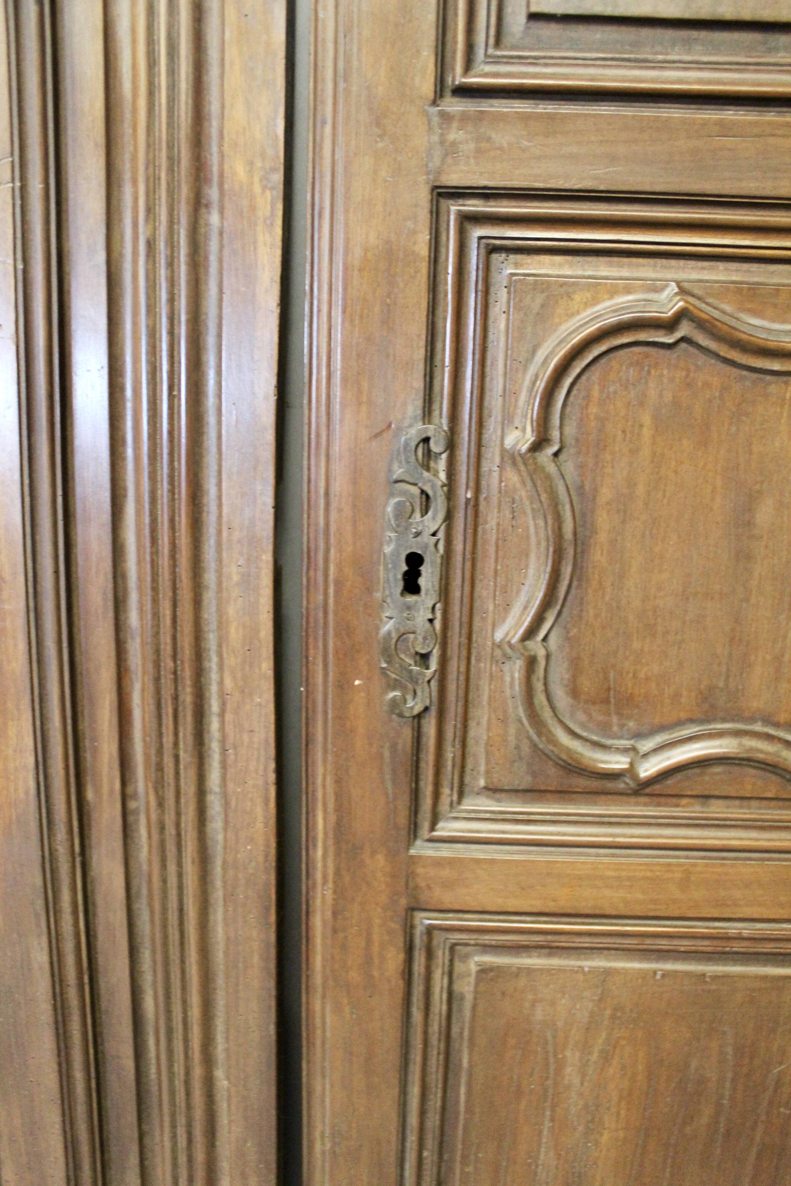 Pair of Louis XV walnut doors with medallion