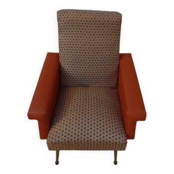Vintage rockabilly retro armchair in orange faux leather and fabric.