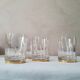 4 crystal whiskey glasses on gold frame
