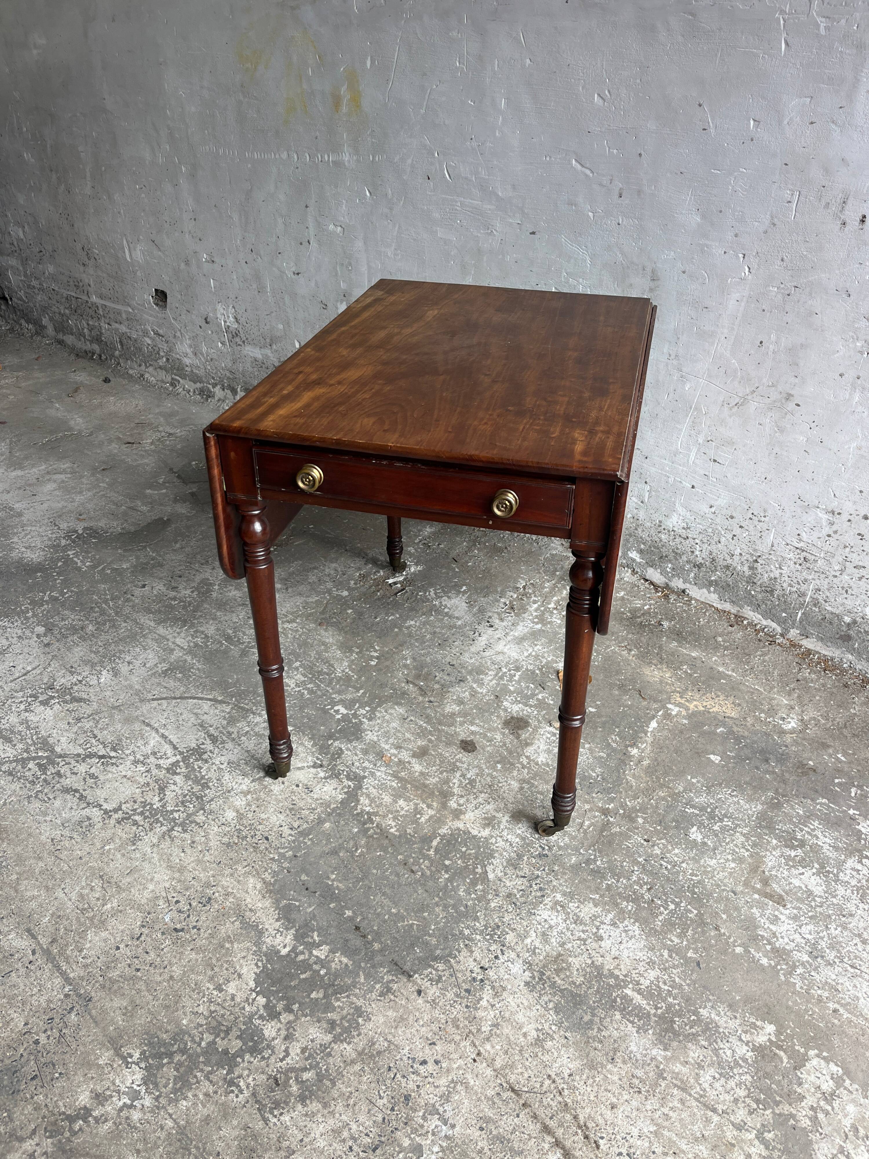 Antique drop-leaf side table on wheels