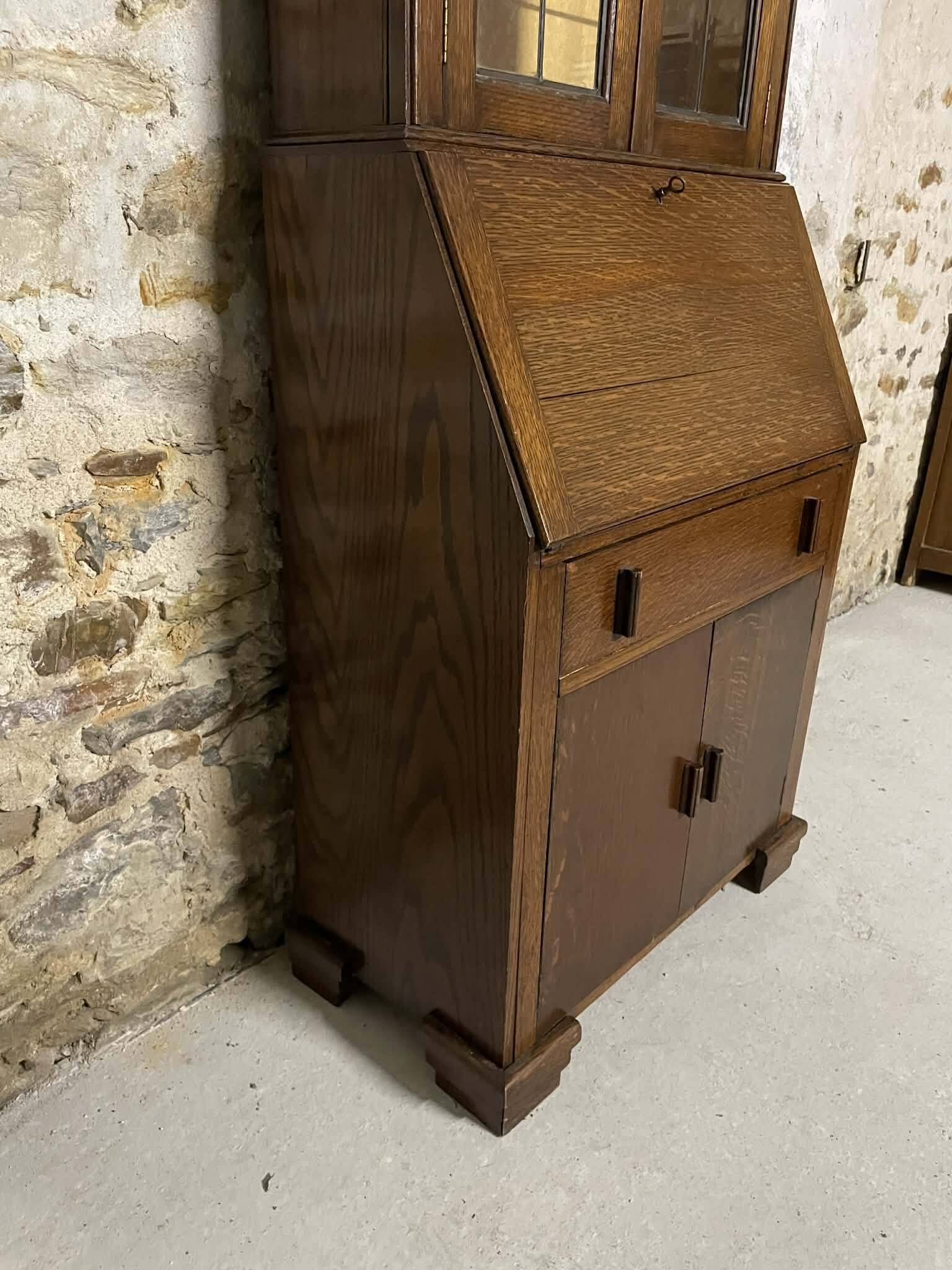 Oak display secretary cabinet with drop-down front, two sections.