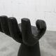 Black armchair chair in carved wood in the shape of a hand