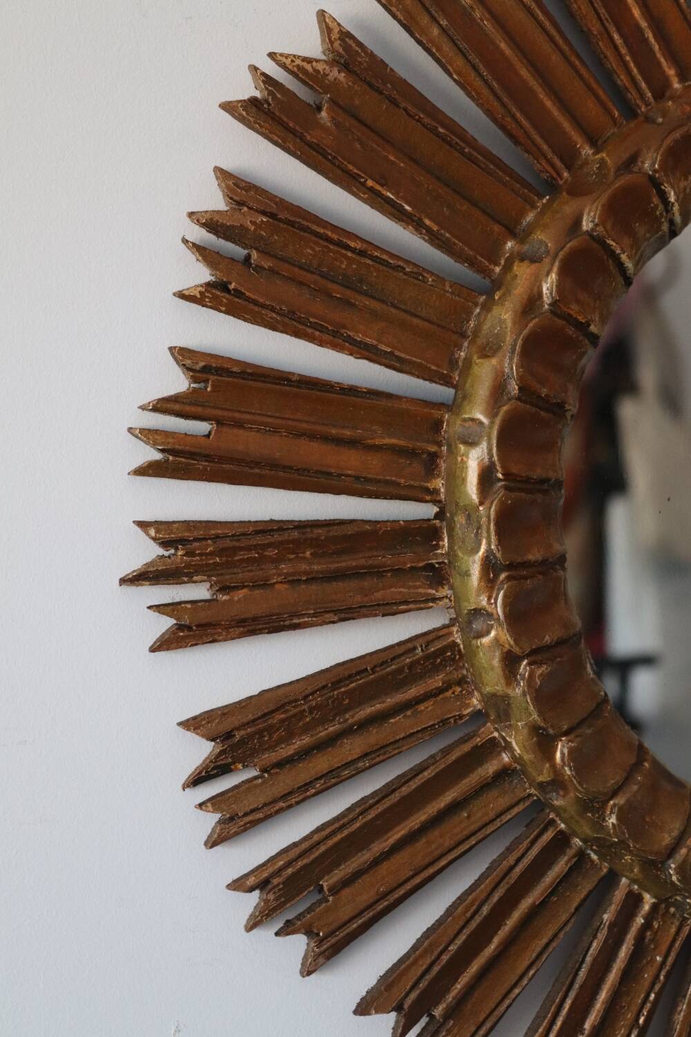 Old large sun mirror in gilded wood