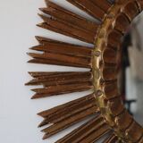 Old large sun mirror in gilded wood