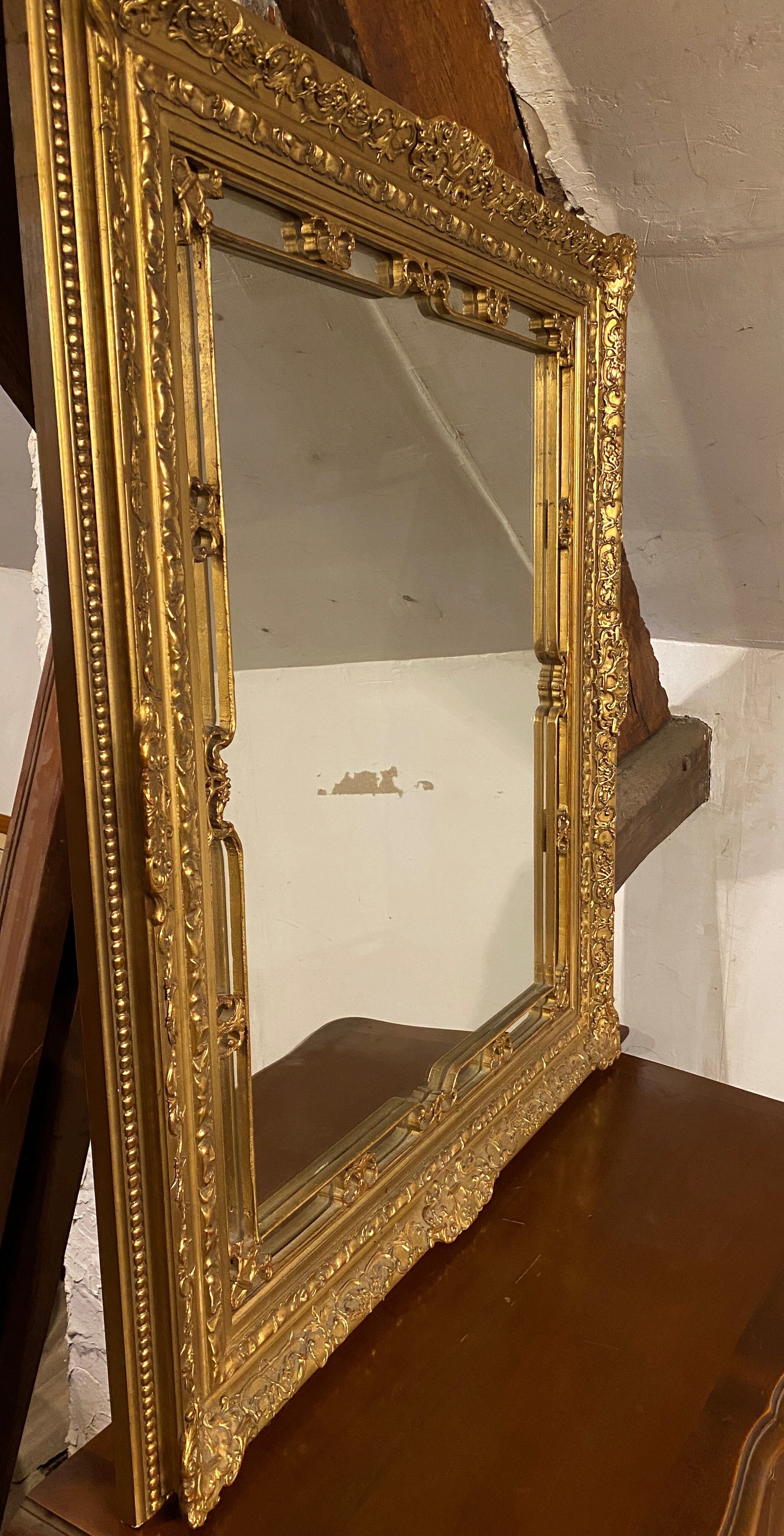 Wooden mirror with gilded stucco