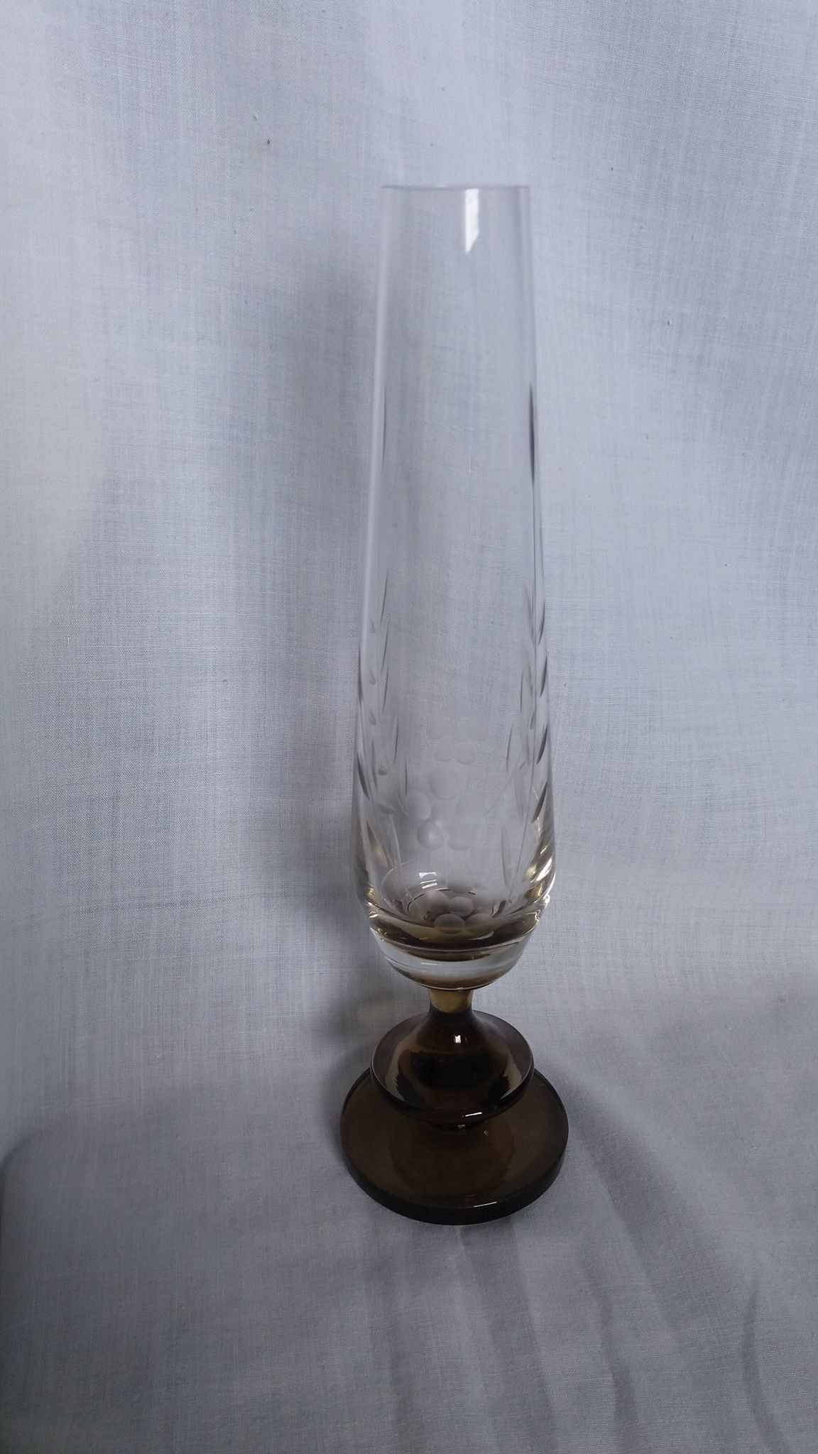 Cut glass soliflore vase with a smoked glass base.