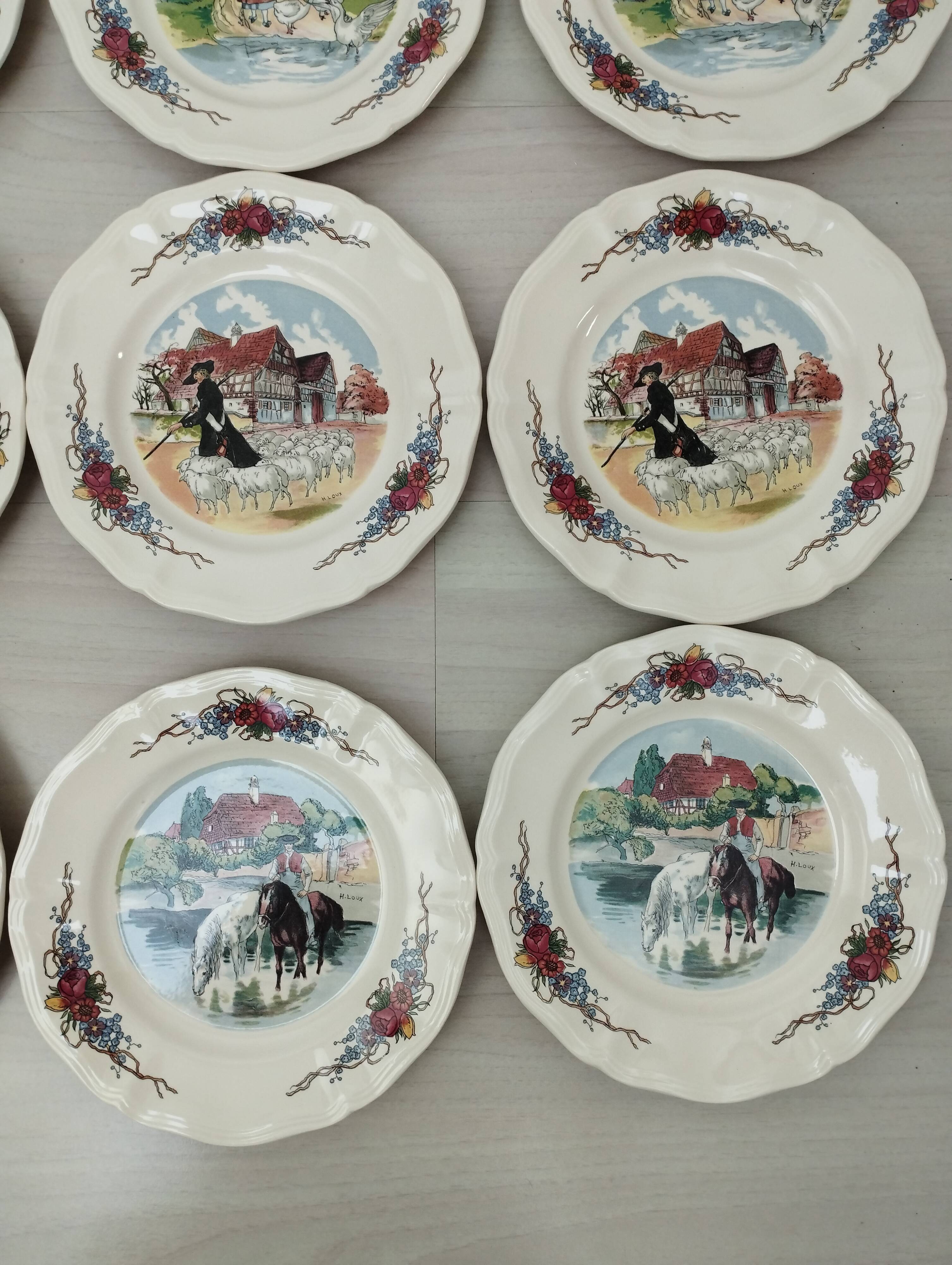 12 plates of the Obernai earthenware décor service signed Henri Loux