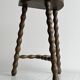 Three-legged demi-lune stool made of turned wood