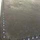 large industrial table in graphite black riveted metal