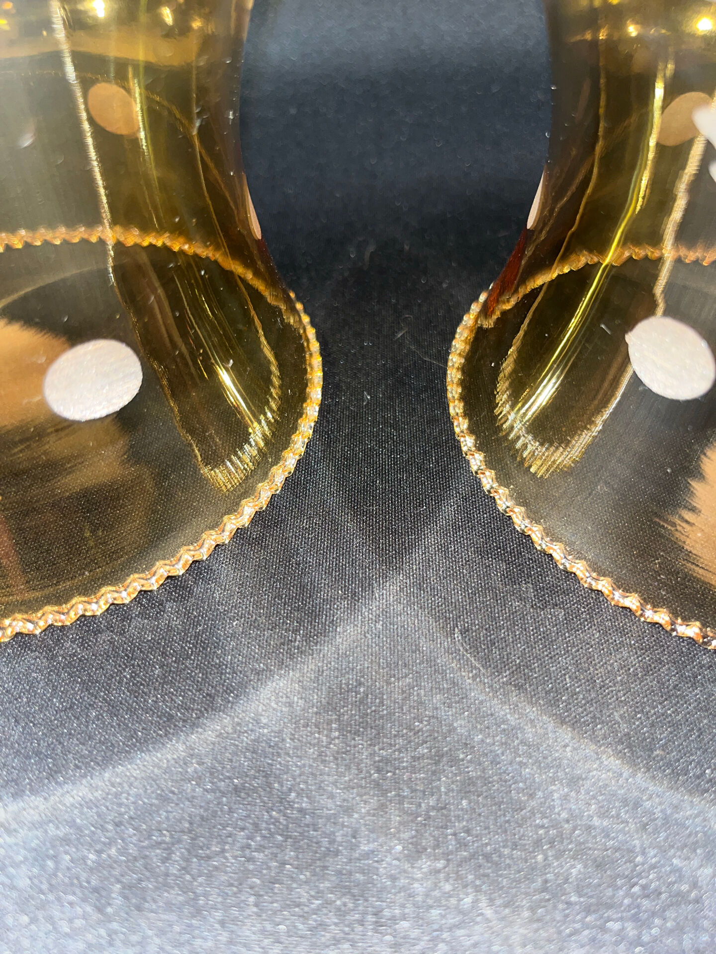 Pair of vintage wall sconces in brass with amber glass globes.