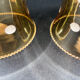 Pair of vintage wall sconces in brass with amber glass globes.