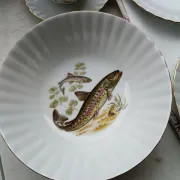 vintage porcelain dinner service with fish pattern and gold trim