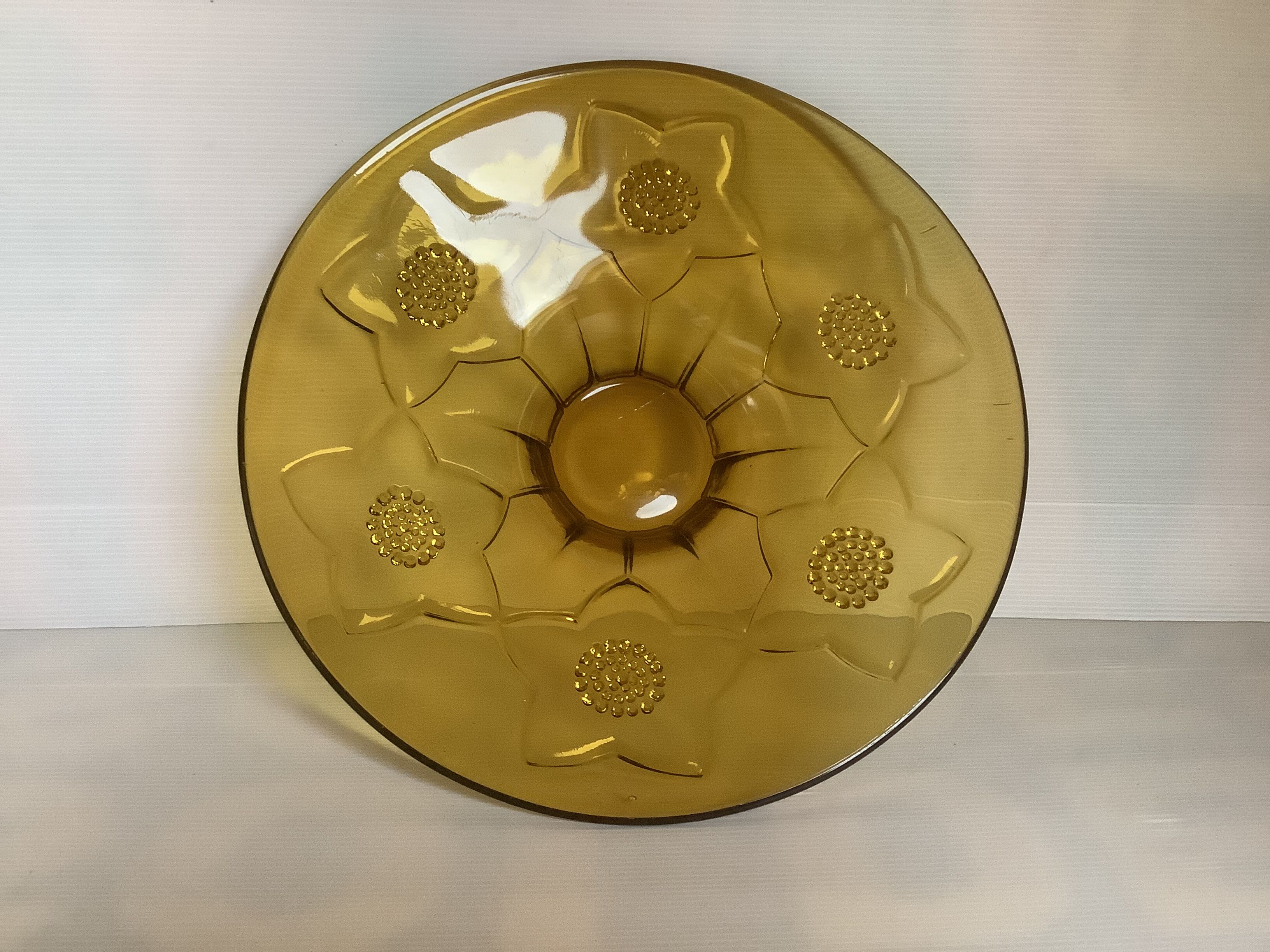 Yellow glass cup with a floral pattern