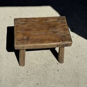 Small stool, rectangular solid teak side table with curved legs.